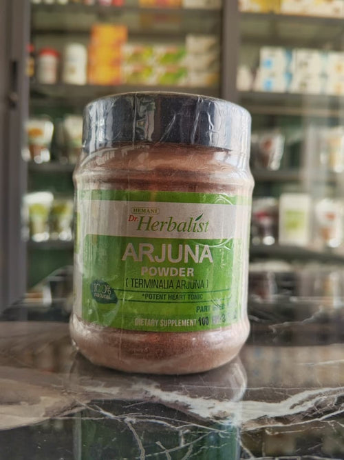 Organic Dr Herbalist Arjuna Powder by Dyroo Naturals in a 100g package, showing fine greenish powder in a clear container.