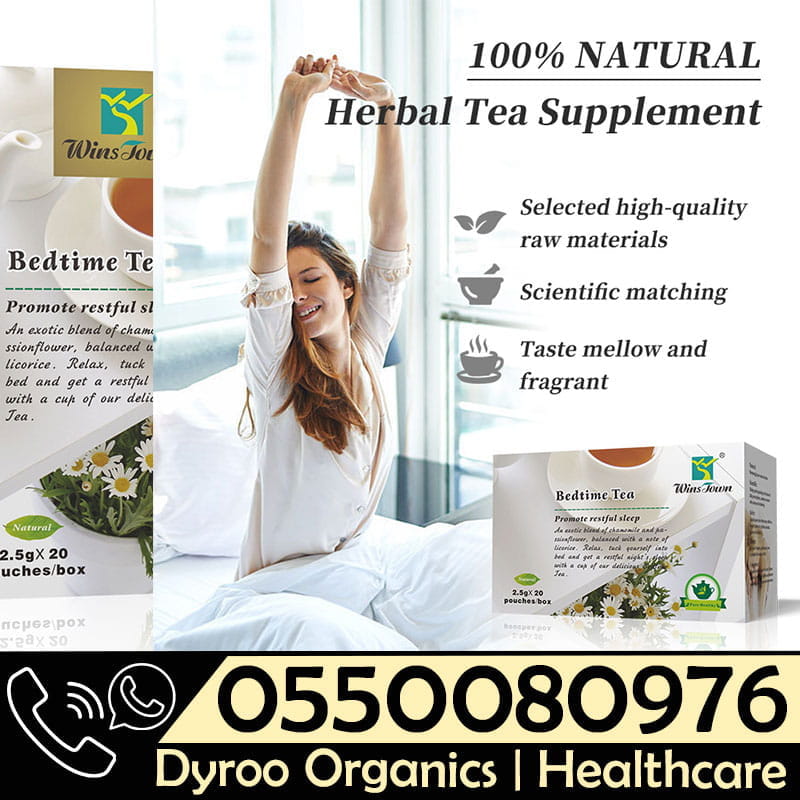 A cup of Dyroo Naturals Wins Town Bedtime Tea with herbal ingredients, displayed on a wooden table with tea leaves nearby.