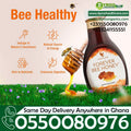 Golden honey syrup in a jar, labeled Forever Living Bee Honey 500g by Dyroo Naturals, with a honey dipper nearby.