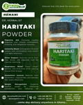 Organic Dyroo Naturals Haritaki Powder in a clear jar, showing fine yellowish powder, 100g packaging for herbal health.